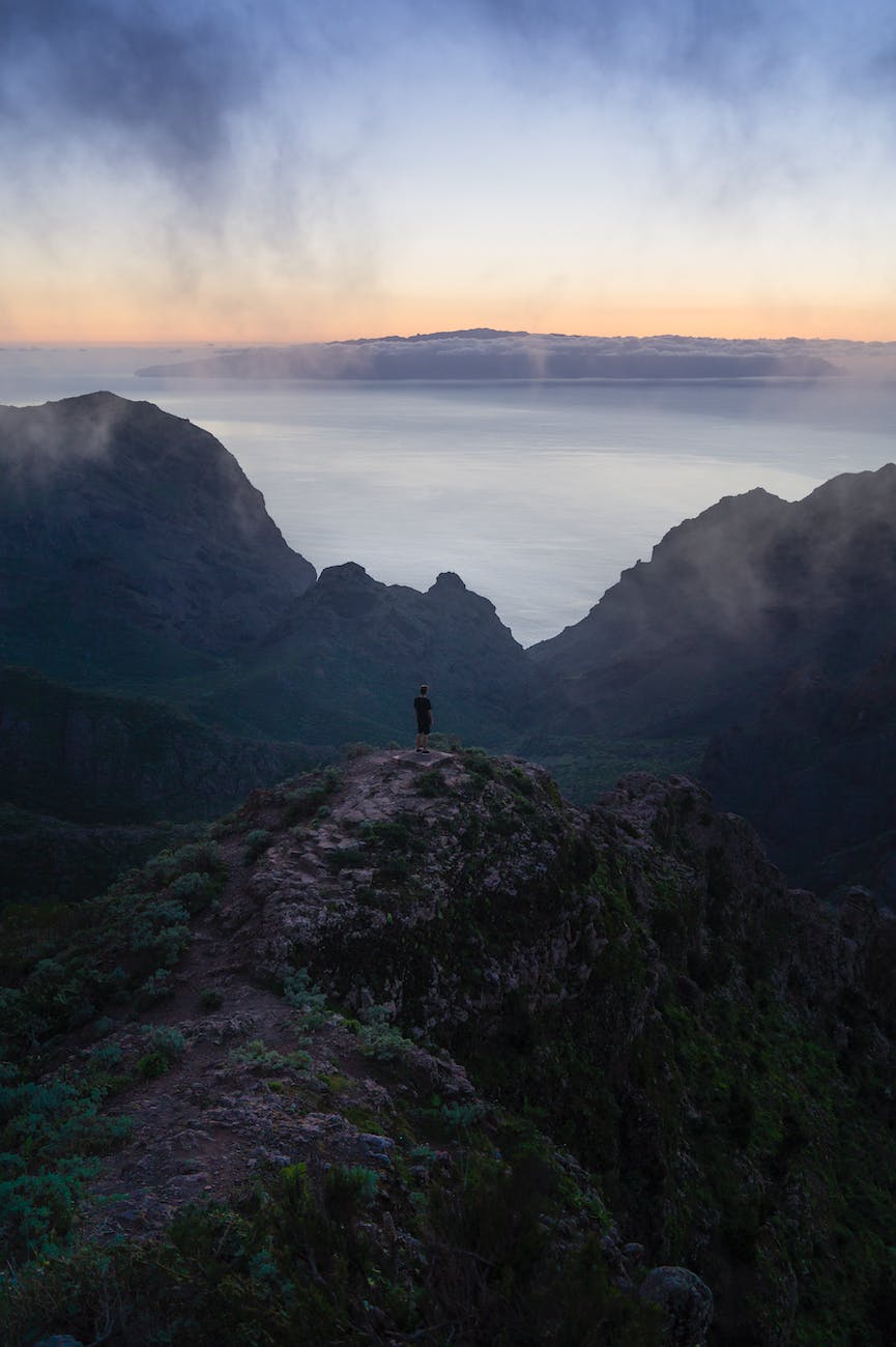 person standing on top of mountain